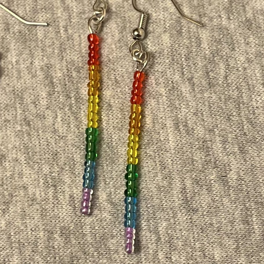 One pair of earrings made of size 12.0 semi-transparent glass seed beads in the traditional rainbow colours: red, orange, yellow, green, blue, purple.
